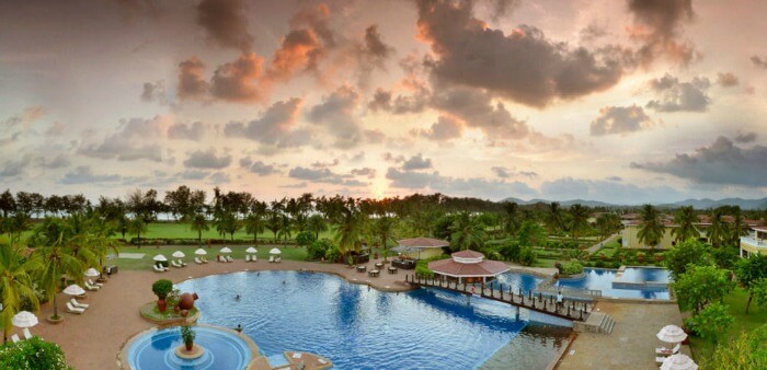 The landscaped gardens and poolside deck of the The Lalit Golf & Spa Resort Goa