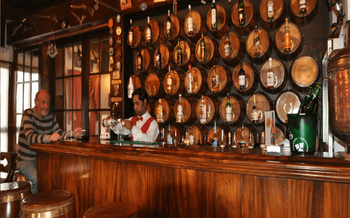 A bartender attends to a guest at the 19th Hole Pub