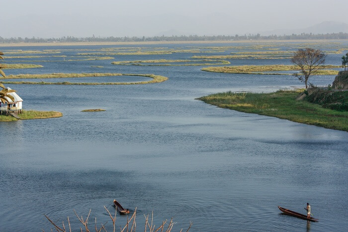 Fisherman in boat at Loktak Lake in Manipur