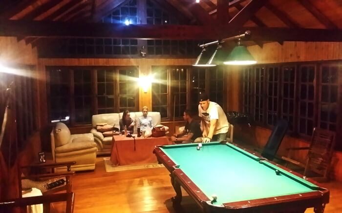 A tourist enjoys playing snooker at the Lake View Pub