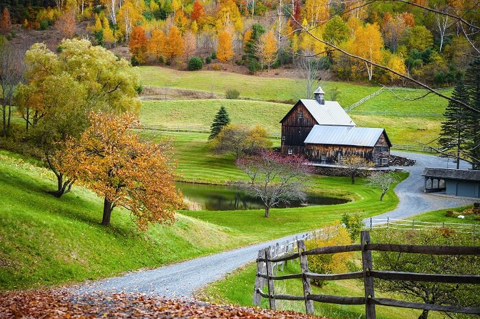 Old wooden barn surrounded by colorful trees at Woodstock in Vermont