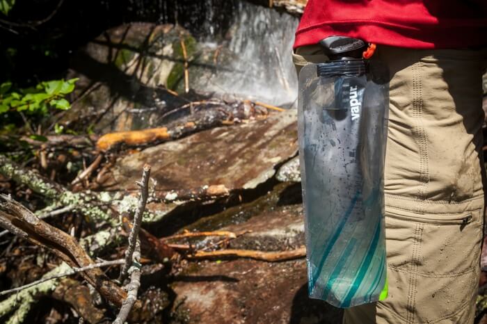 A traveler carrying a vapor microfilter bottle
