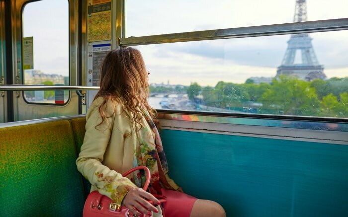 A woman traveling train going past the Eiffel Tower in Paris