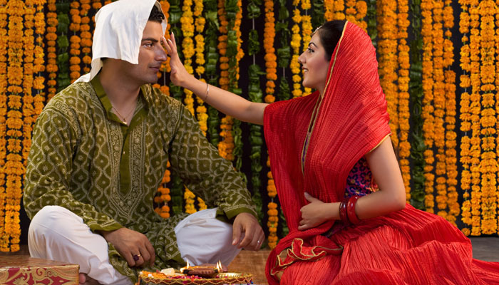 A sister puts tilak on the forehead of her brother during the Bhai Dooj celebrations in India