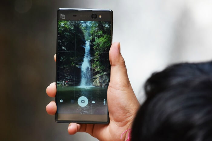 my friends clicking pictures of the pretty waterfall