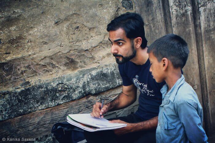 kid curiously watching rahul sketch