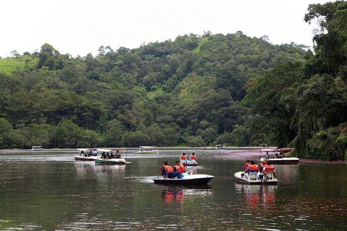 Tourists boating in the Pookode Lake in Kerala