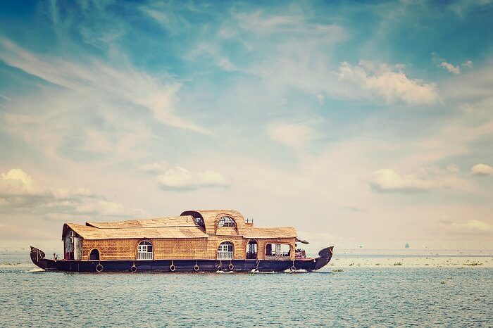 Retro styled image of houseboat in Vembanadu Lake