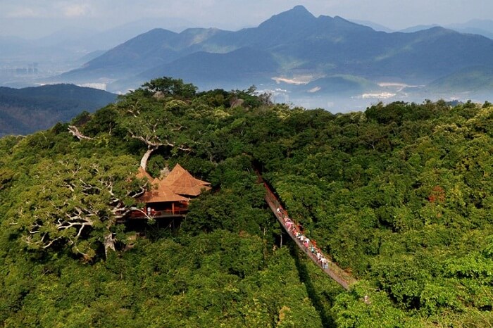 Tourists walk on the suspension bridge in Hainan