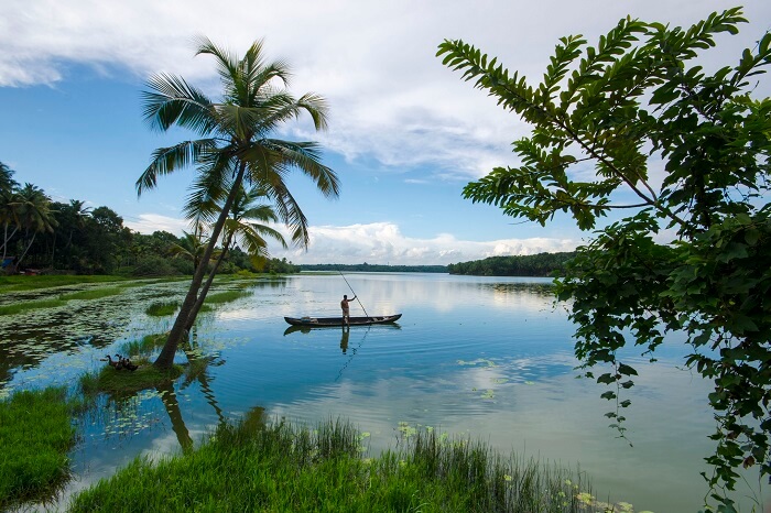 A fisherman on his boat in the Vellayani Lake