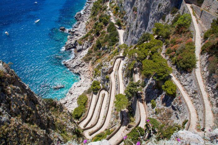 The snake like roads of Italy on the side of a cliff