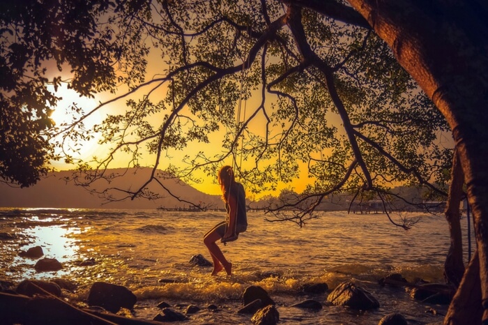 A woman relaxing on a swing at Koh Rong beach in Cambodia