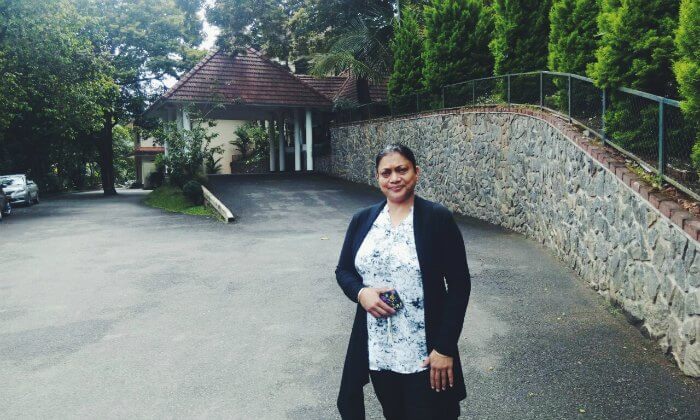 anuj's wife standing outside their hotel in thekkady