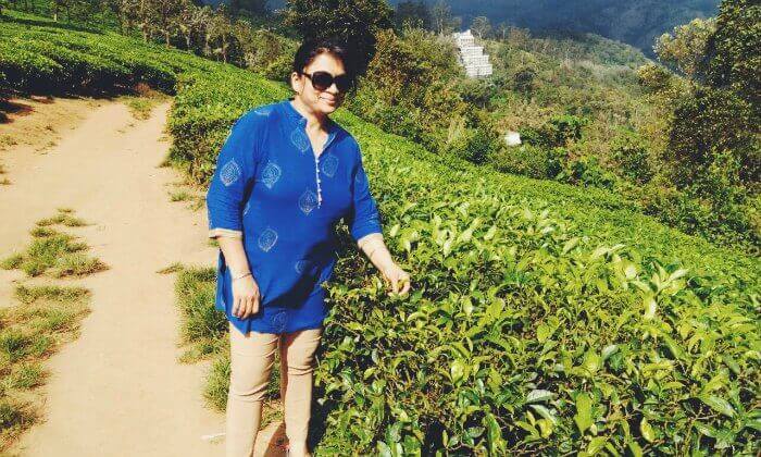 Anuj's wife posing before the tea plantations