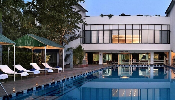 The swimming pool and main building at the Best Western Country Club in Manesar