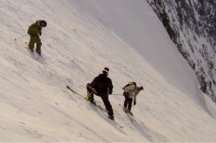 Adventurers skiing on the mountain slope in the documentary The Edge of Never