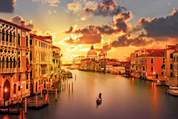 Man sailing a boat into the sunset in Grand Canal in Venice
