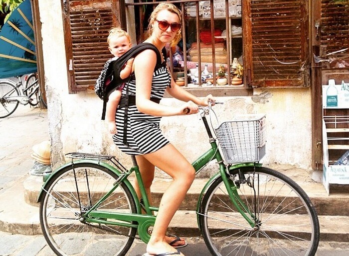 Woman cycling with baby