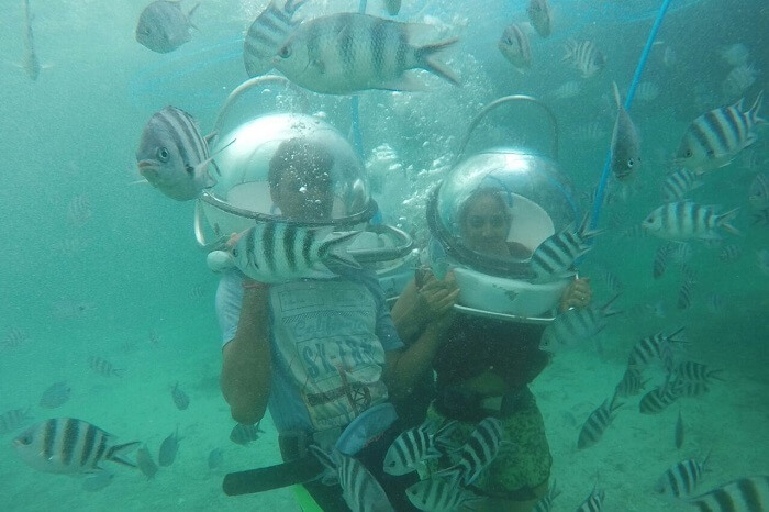 Couple enjoying underwater seawalking