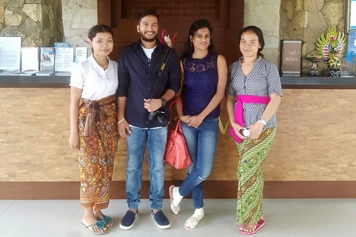 Couple taking picture with locals of Bali
