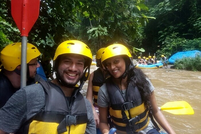 Couple engaging in river rafting