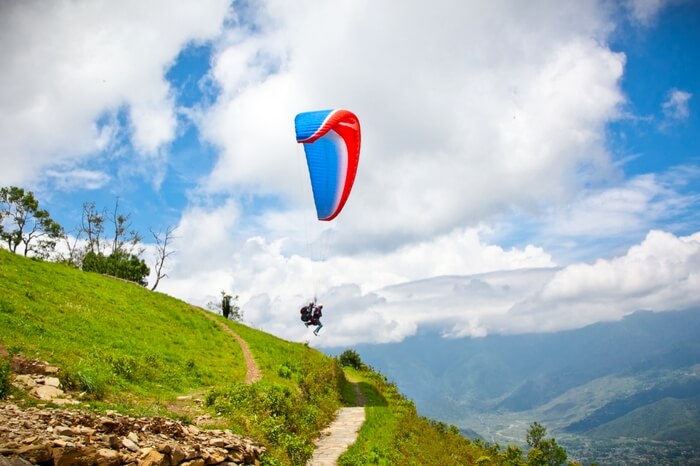 Paraglider jumping off a cliff in Khajjiar