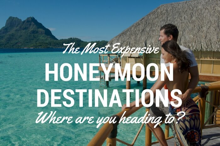 A couple stands outside an overwater villa in Bora Bora that is one of the luxury honeymoon destinations