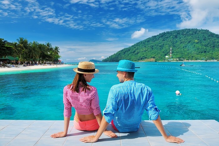 A couple relaxes at a jetty in Malaysia