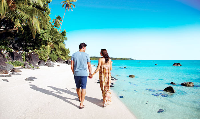 Couple walking on the beach in Cooks Islands