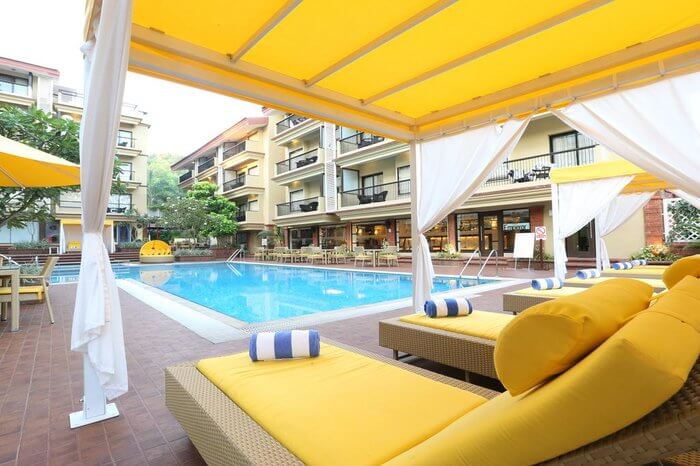 outdoor swimming pool with cabanas