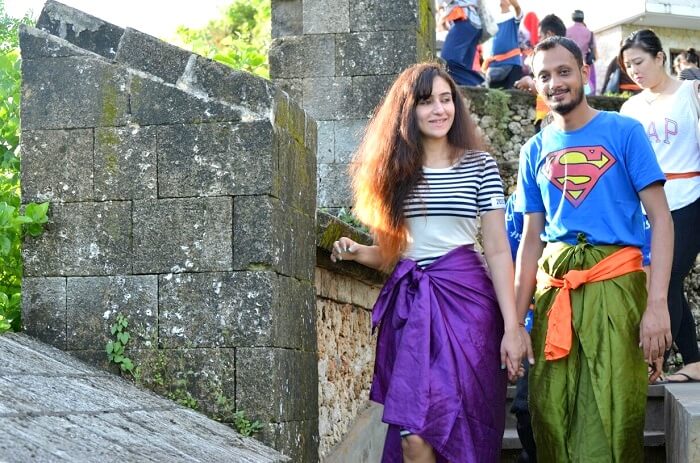 Sanchit and his wife explore the Uluwatu temple in Bali