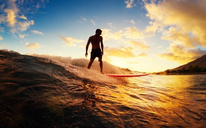 Silhouette of a person surfing in Sri Lanka