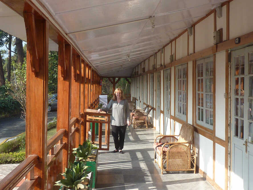A women on the porch of Pinewood Hotel