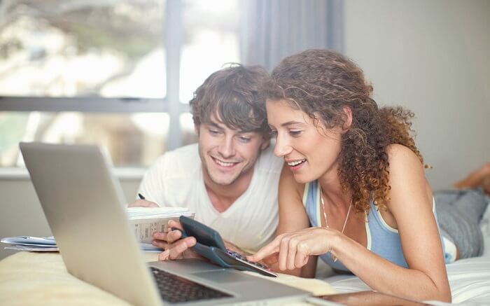 Couple planning and researching for honeymoon
