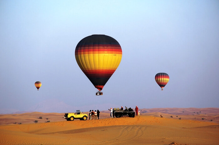 Travelers taking up hot air balloon ride during desert safari in Dubai