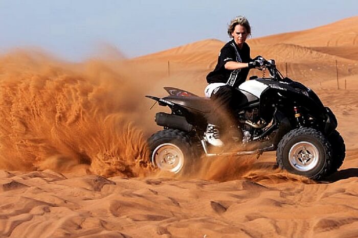 Traveler taking up dune bashing during desert safari in Dubai