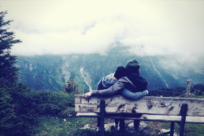 Couple sitting by the valley during their honeymoon in Uttarakhand