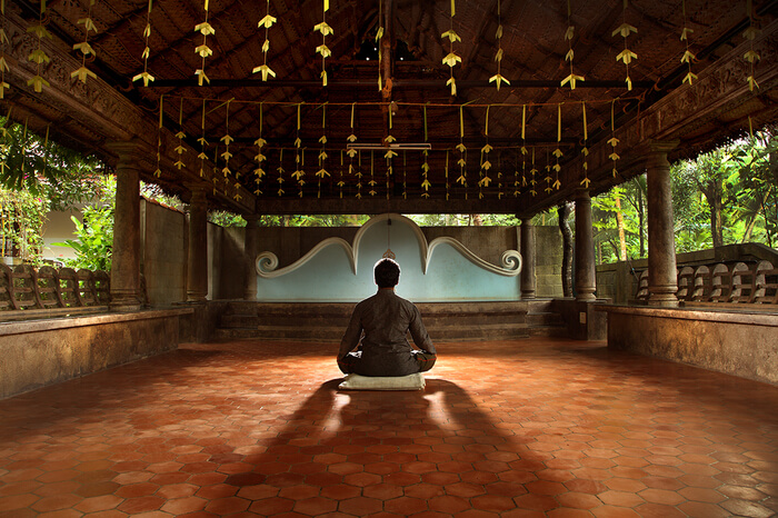 a guy meditating in an ashram