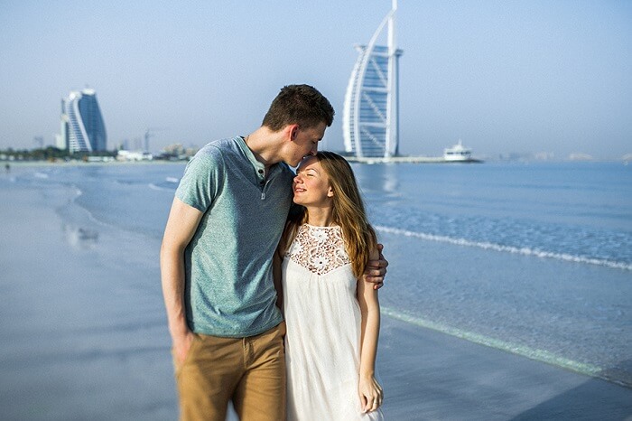 Romantic couple walking on the beach in Dubai