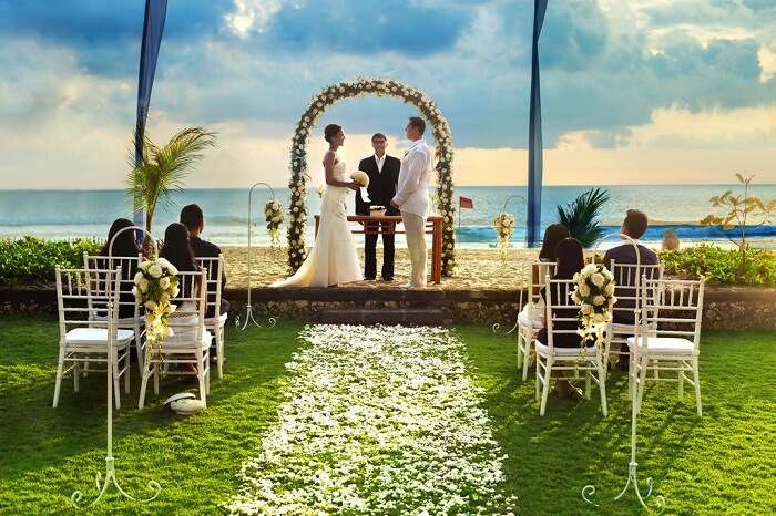 A couple exchanging vows at The Oberoi in Bali