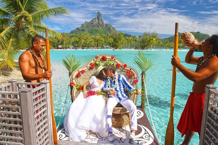 A couple kisses after getting married at Le Meridien in Bora Bora