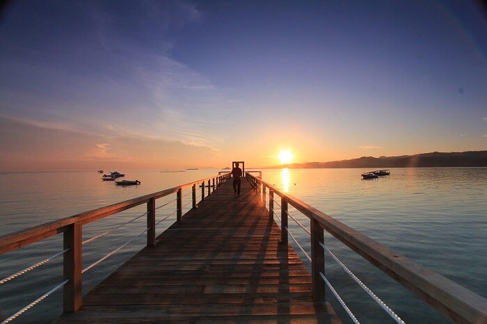 A beautiful shot of a sunset over the jetty on Gili Gede