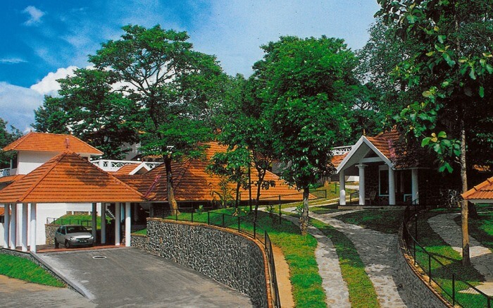 red and white painted bungalows of Hotel Treetop in Thekkady