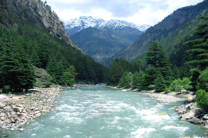 a river flowing in the middle of the mountains
