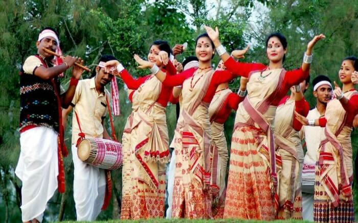 Assamese women and men dancing during Bihu festival ss22052017