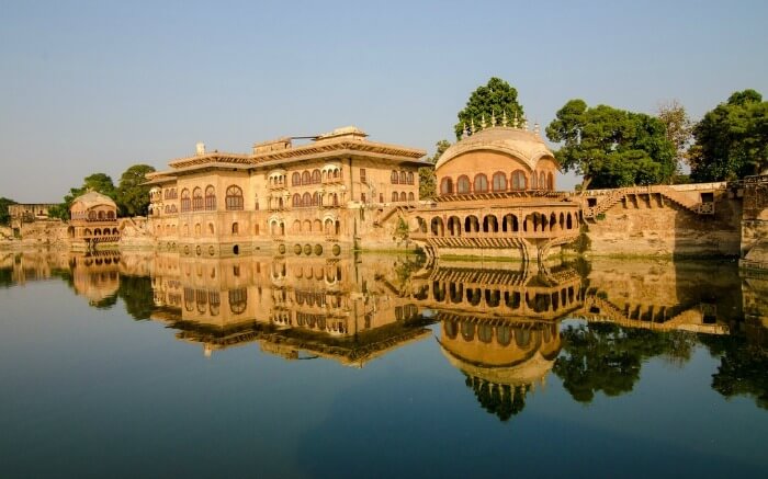 Deeg Palace reflection on lake water