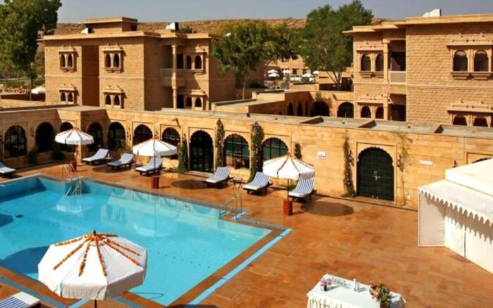 Gorbandh Palace pool area with cabanas around