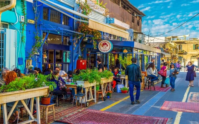 Israelis sitting in a roadside cafe in Flea market in Israel