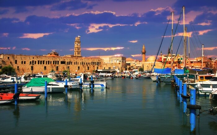 View on marina with yachts and ancient walls of harbor in Acre, Israel.