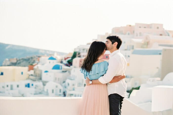 a young honeymoon couple in Santorini
